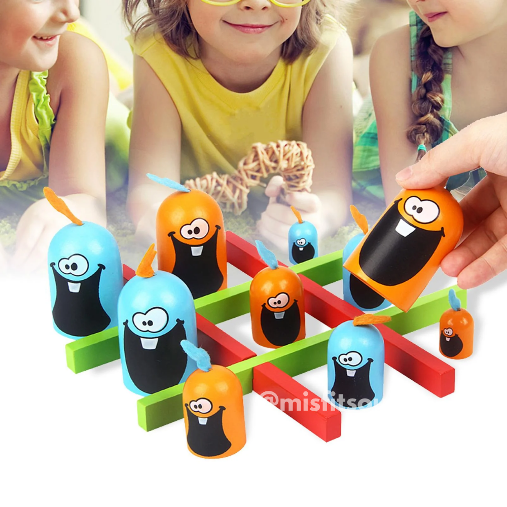Children playing Gobble Game outdoors with bright orange and blue cartoon stacking pieces on a green and red tic-tac-toe board. Fun interactive family toy perfect for outdoor or indoor play.