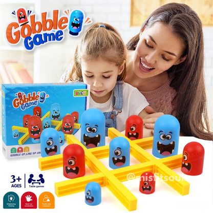 Mother and child playing Gobble Game, a colorful 3D tic-tac-toe board game with fun cartoon-faced gobbler pieces in red and blue. Educational family board game for kids aged 3+, perfect for early learning, strategy building, and family fun.
